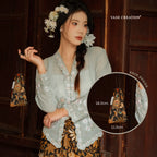 A pretty charming nyonya lady holding  Vase Creation Heritage Batik Journey Set