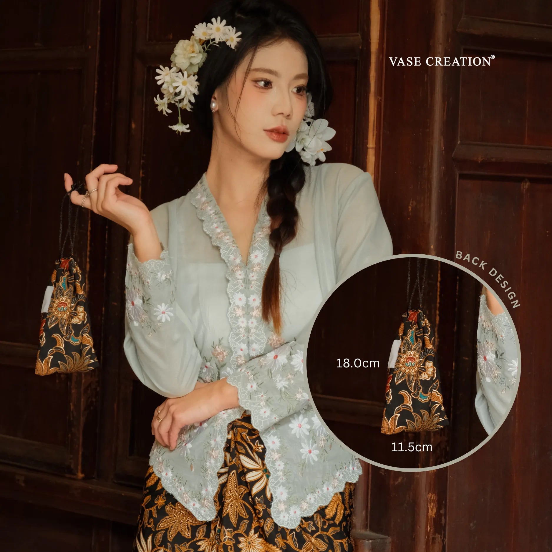 A pretty charming nyonya lady holding  Vase Creation Heritage Batik Journey Set