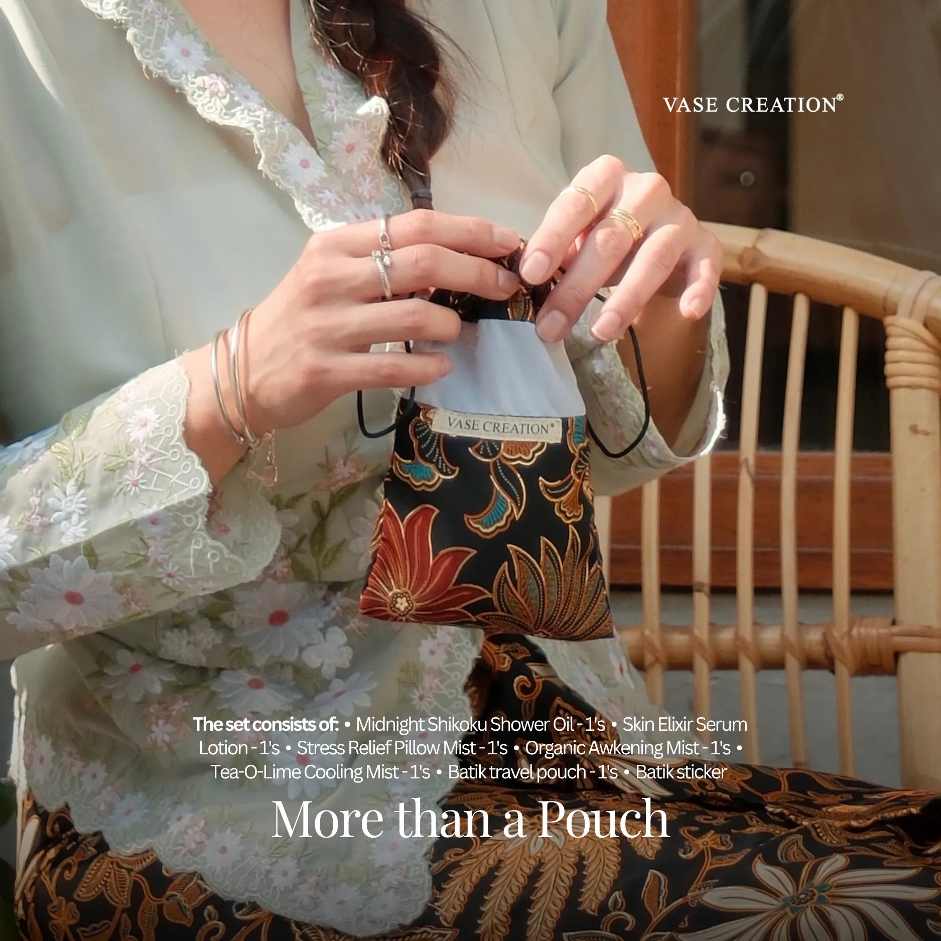 A lady wearing nyonya batik and holding Vase Creation Heritage Batik Journey Set